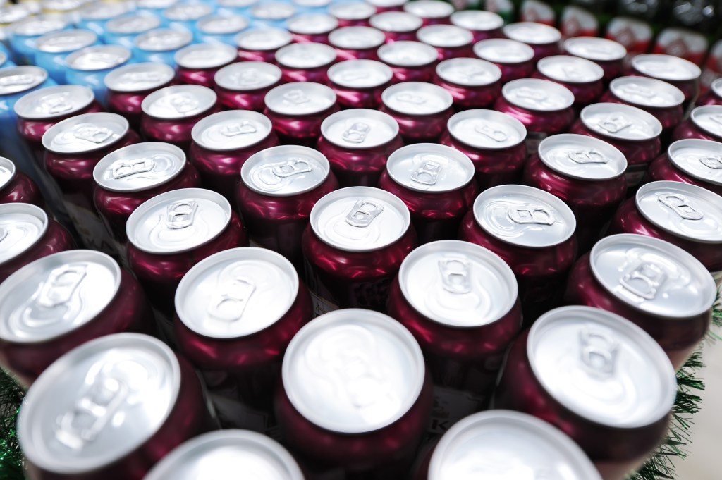 Top view of many soft drink cans in a supermarket.