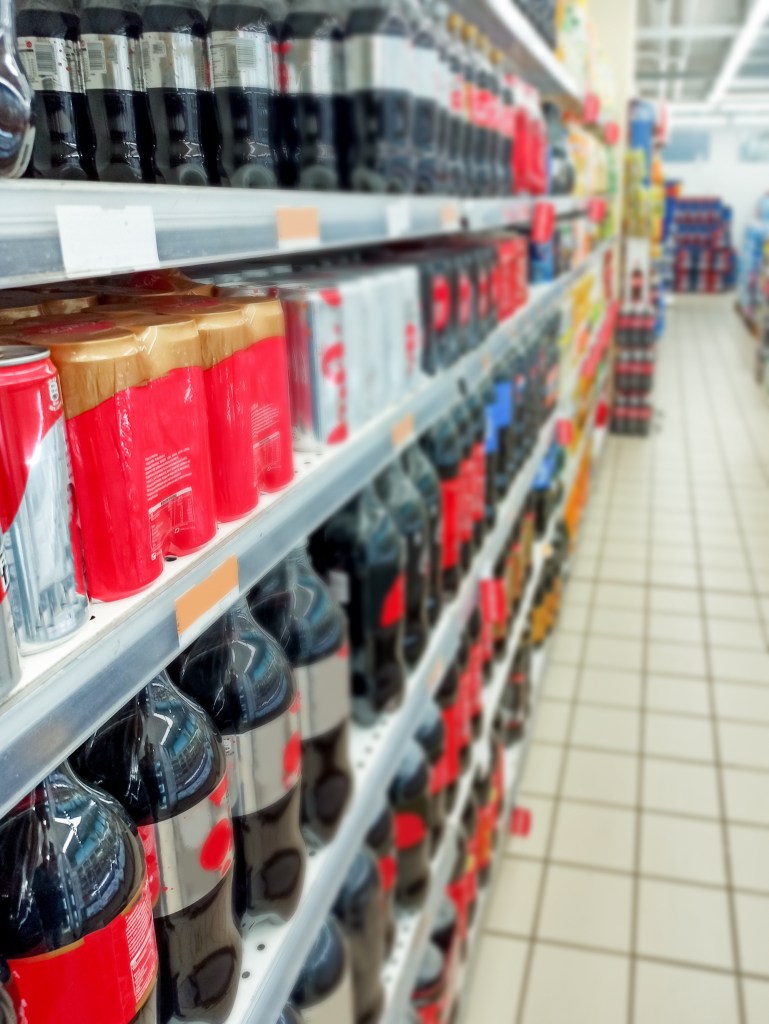 Soft drinks on supermarket shelves.