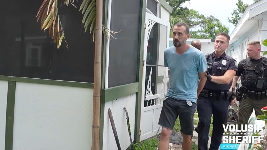 Scott Allen Gardner is escorted by Florida police officers during his arrest on June 19, 2025.