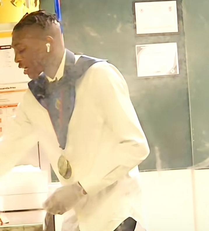 Mykale Baker wears his graduation stole and medals while working at a Burger King in Georgia on May 21, 2025.