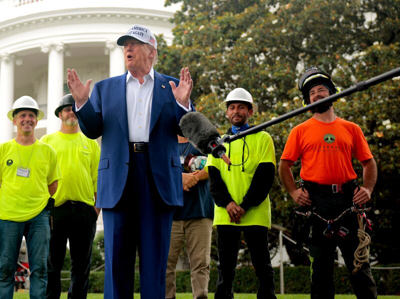 WASHINGTON, DC - JUNE 18: Standing with workers before they install a new flag pole on the South Lawn, U.S. President Donald Trump talks with journalists outside the White House on June 18, 2025 in Washington, DC. Trump said that he personally paid for the pole and another just like it on the North Lawn and their installations. (Photo by Chip Somodevilla/Getty Images)