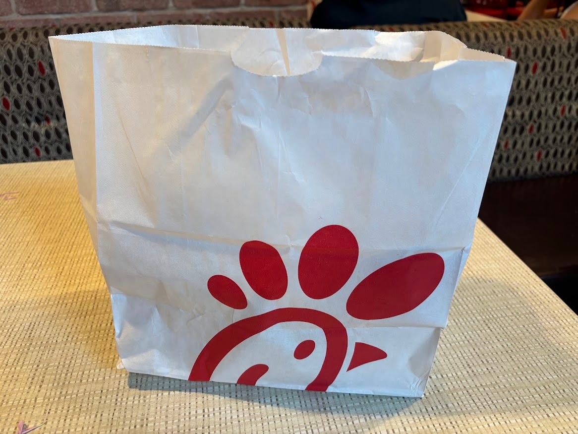 White paper bag with Chick-fil-A logo 
