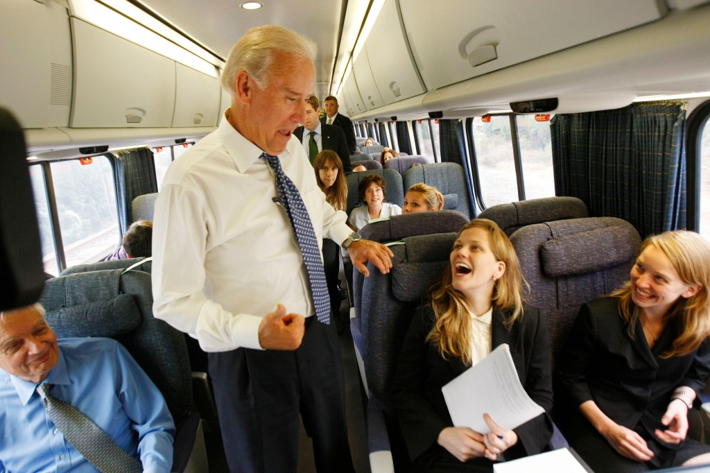 Joe Biden speaking to passengers on an Amtrak train.