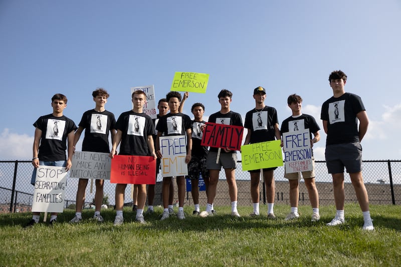 Friends of Emerson Colindres holding protest signs.