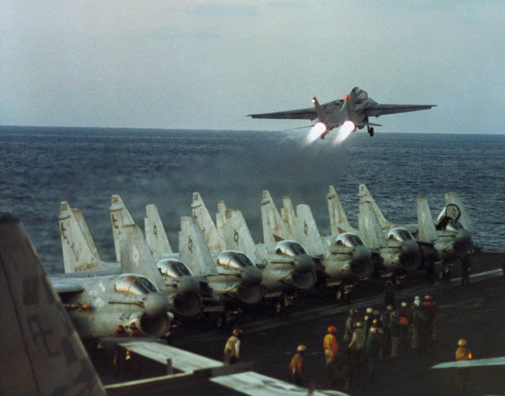 Navy F-14 takes off of of aircraft carrier USS John F. Kennedy