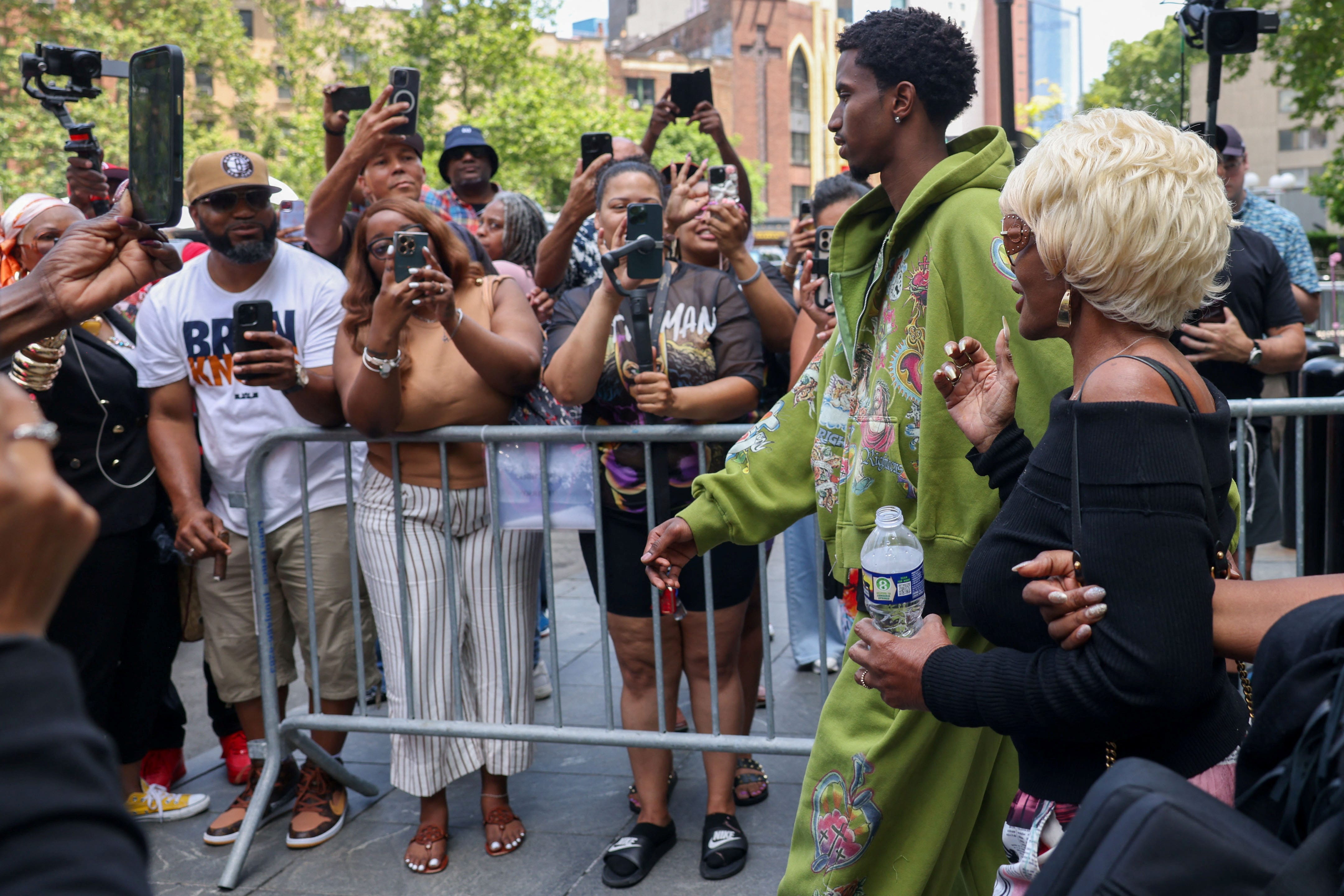 Sean Combs' son, Christian, and mother, Janice, leave court on Friday.