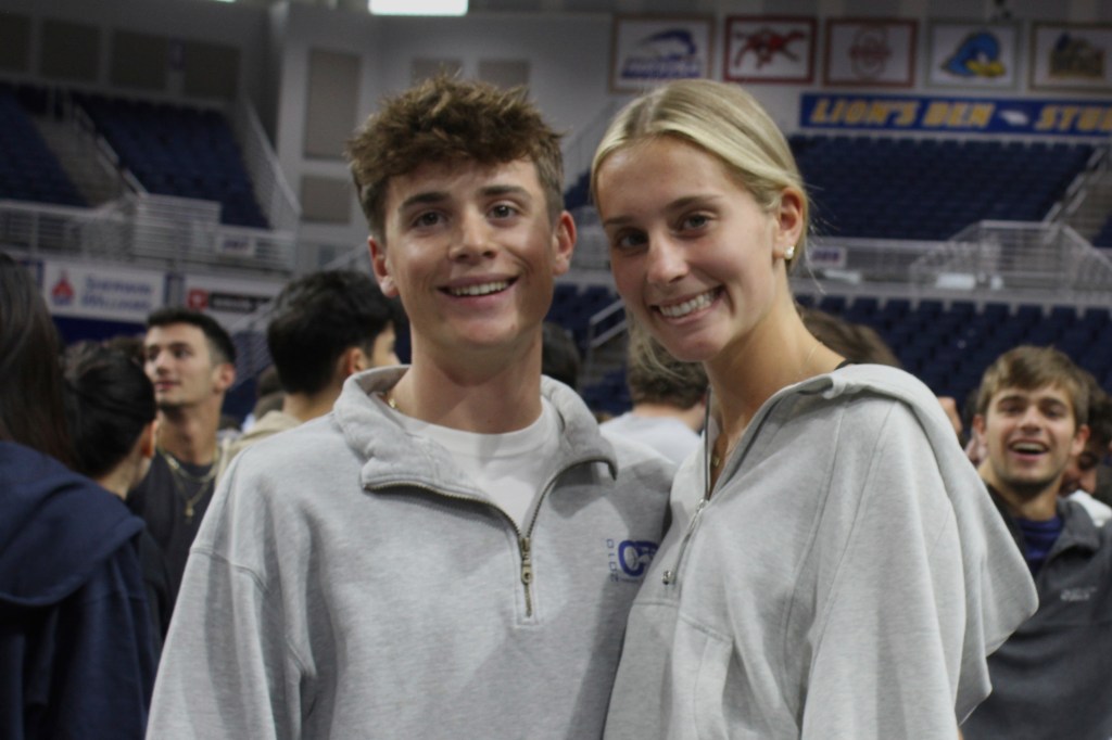 Graduating twins in gray sweatshirts.
