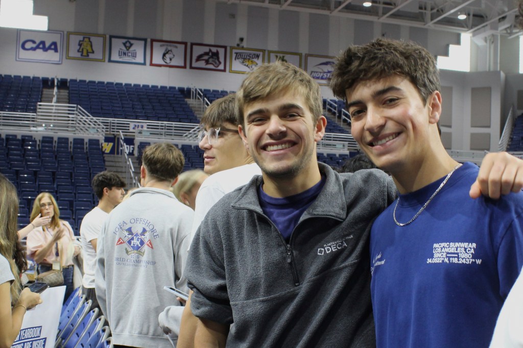 Two smiling twin brothers graduating.
