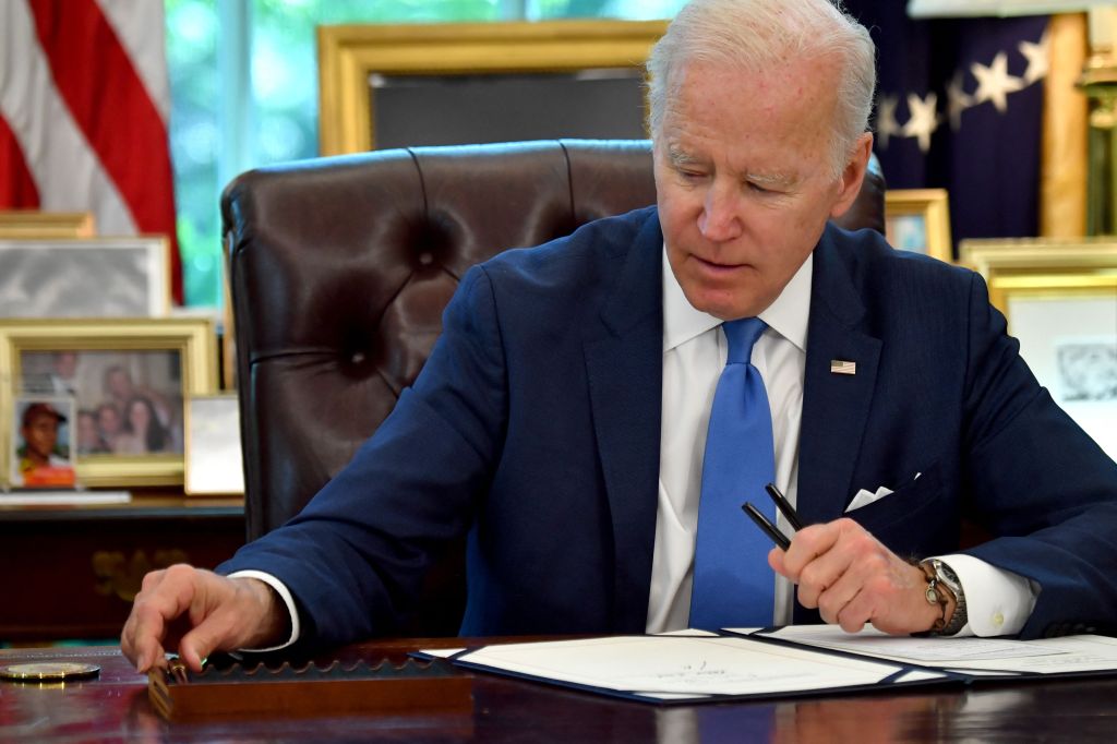 President Joe Biden signs bills in the Oval Office of the White House on May 9, 2022.