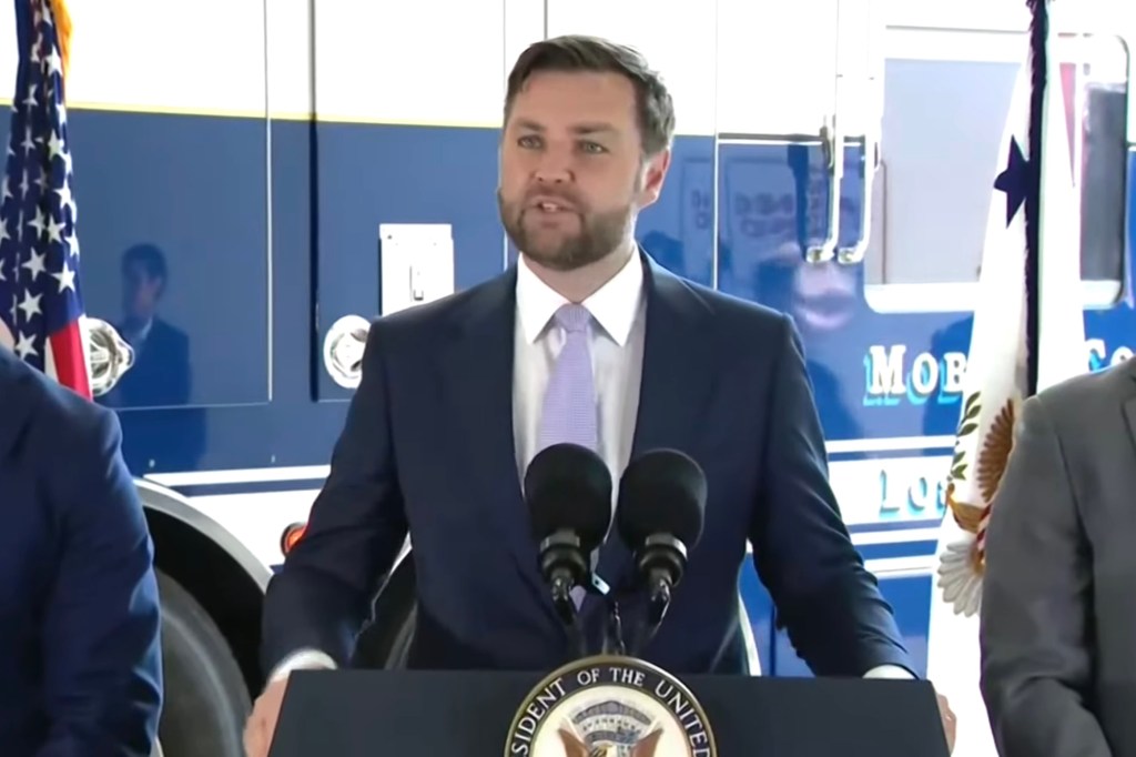 JD Vance speaking at a podium.