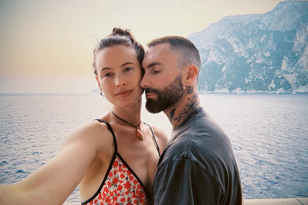 All patched up couple Behati Prinsloo and hubby Adam Levine pose for a sweet vacy pic.