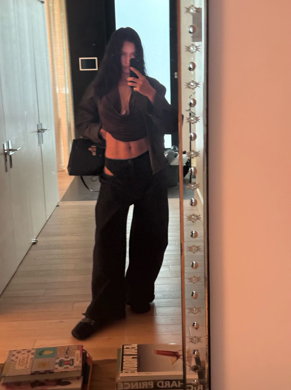 Irina Shayk tries to decide on wearing pants or staying in her underwear.
