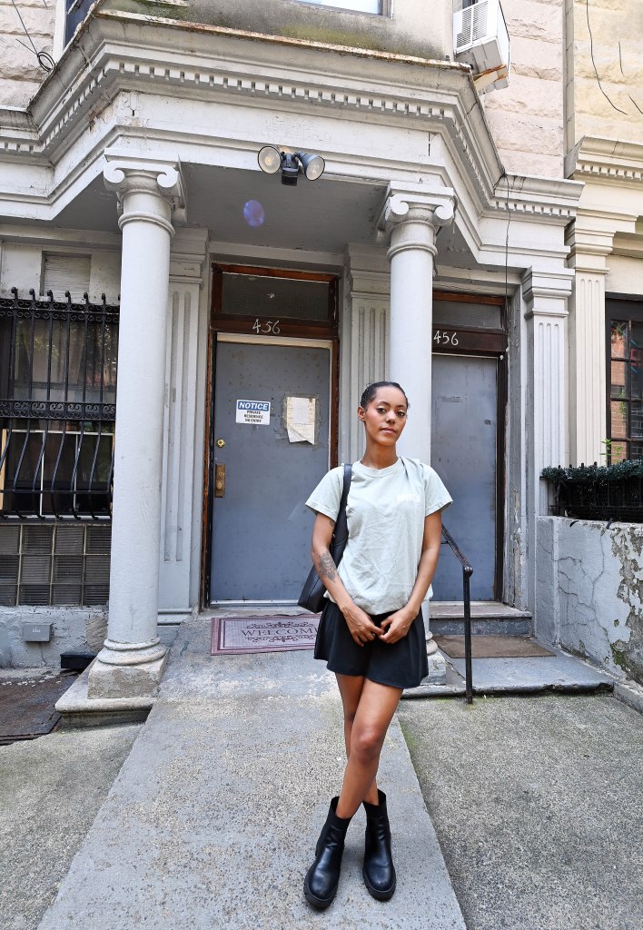 Woman standing in front of her apartment building in New York City.