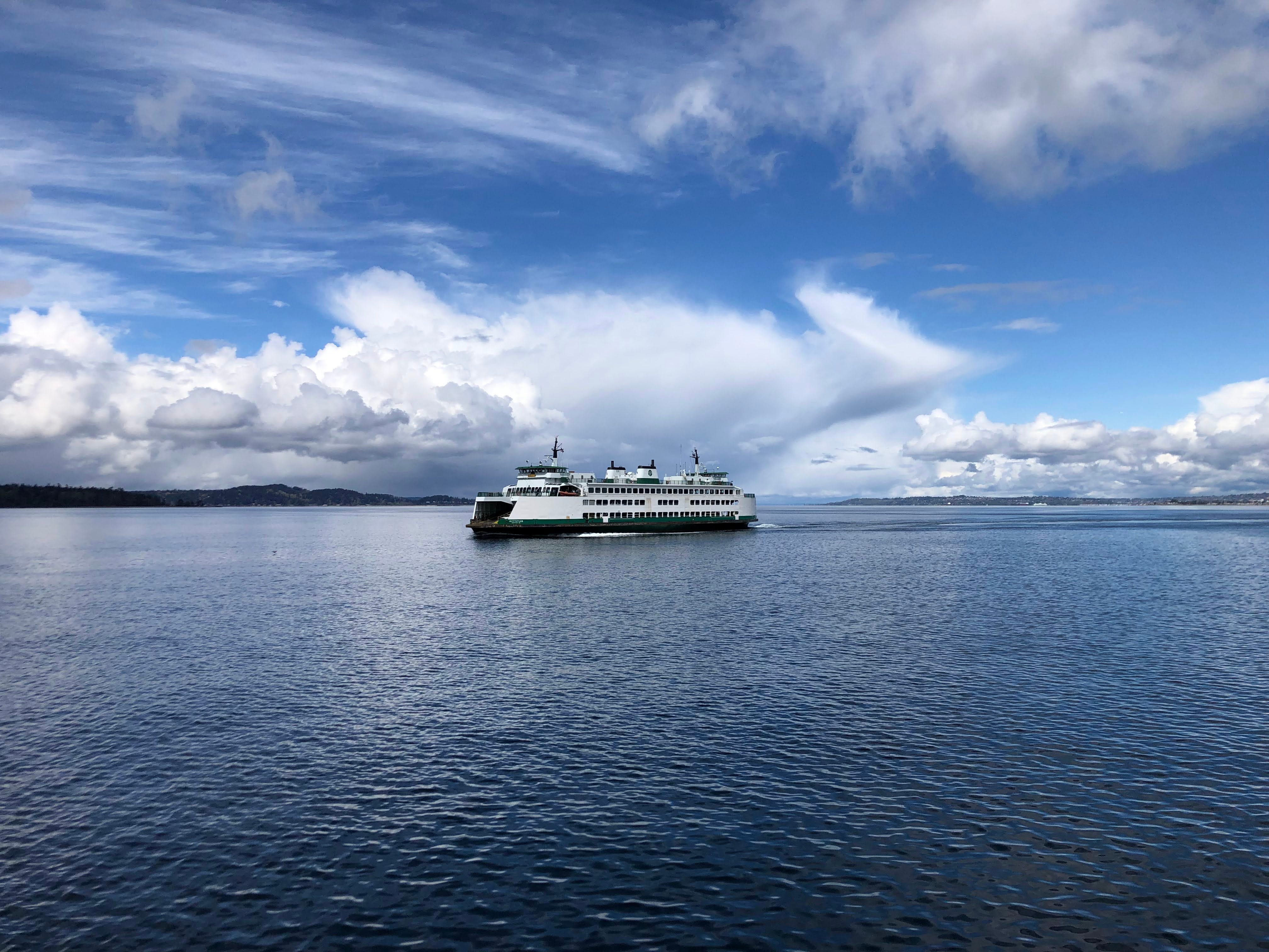 The Washington State Ferry sailing on the Puget Sound on a partly cloudy day.