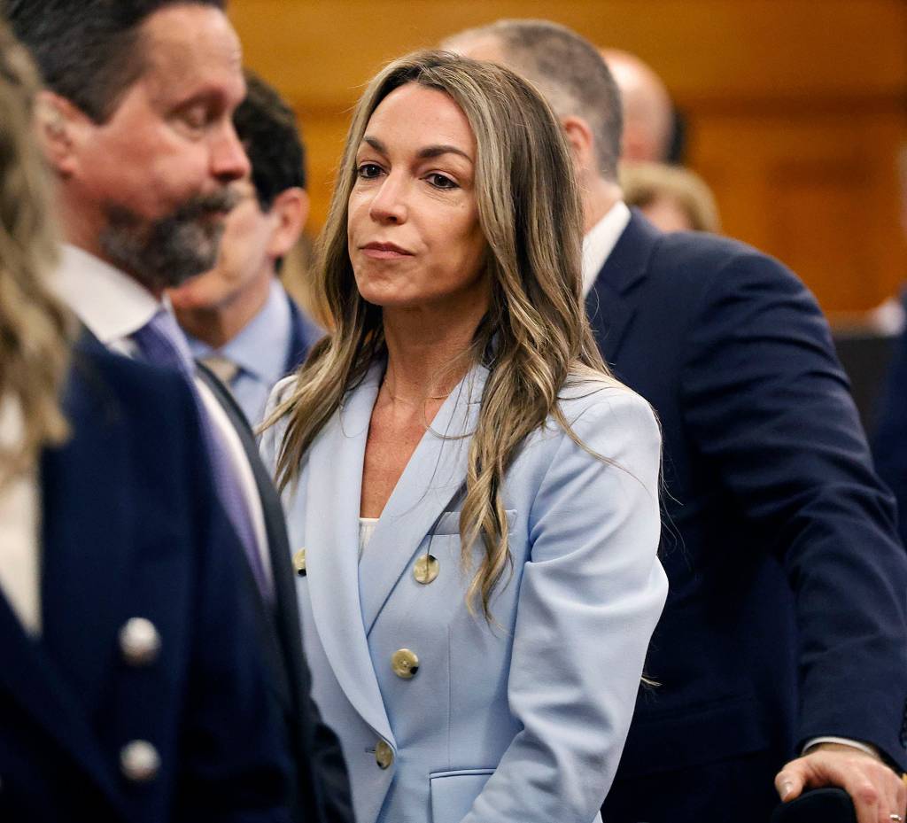 Karen Read in court, seen wearing blue suit with people around her.