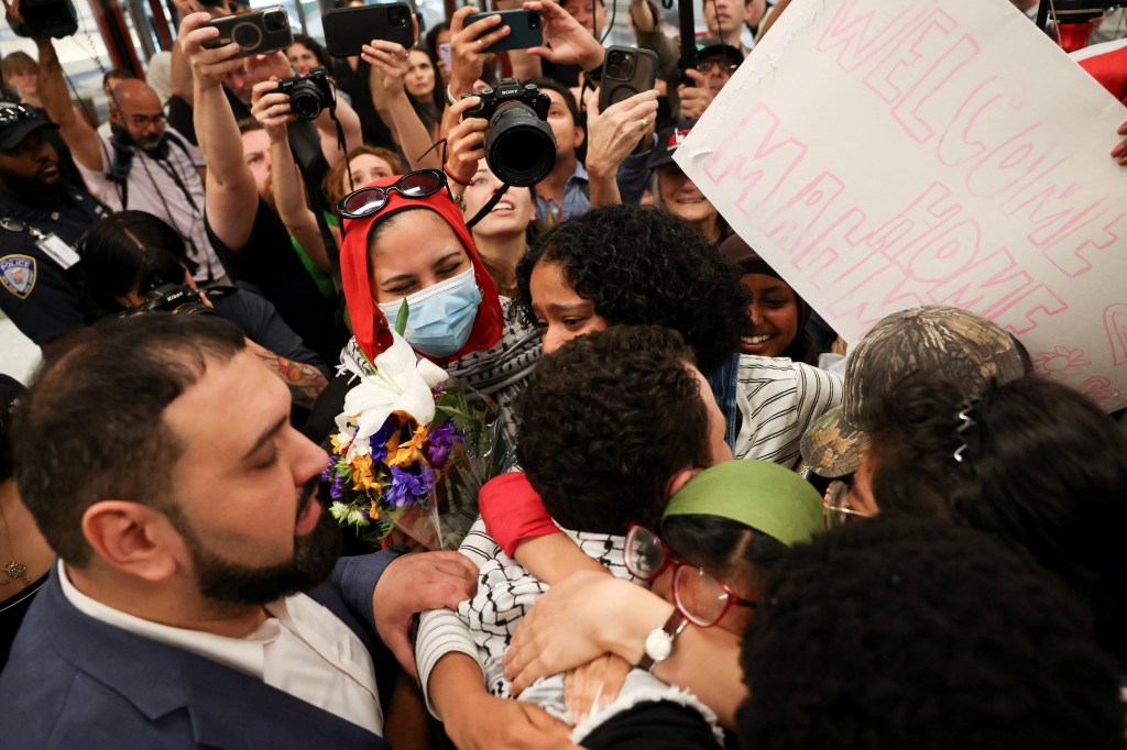 A pro-Palestinian activist is embraced by family and friends upon release from immigration custody.