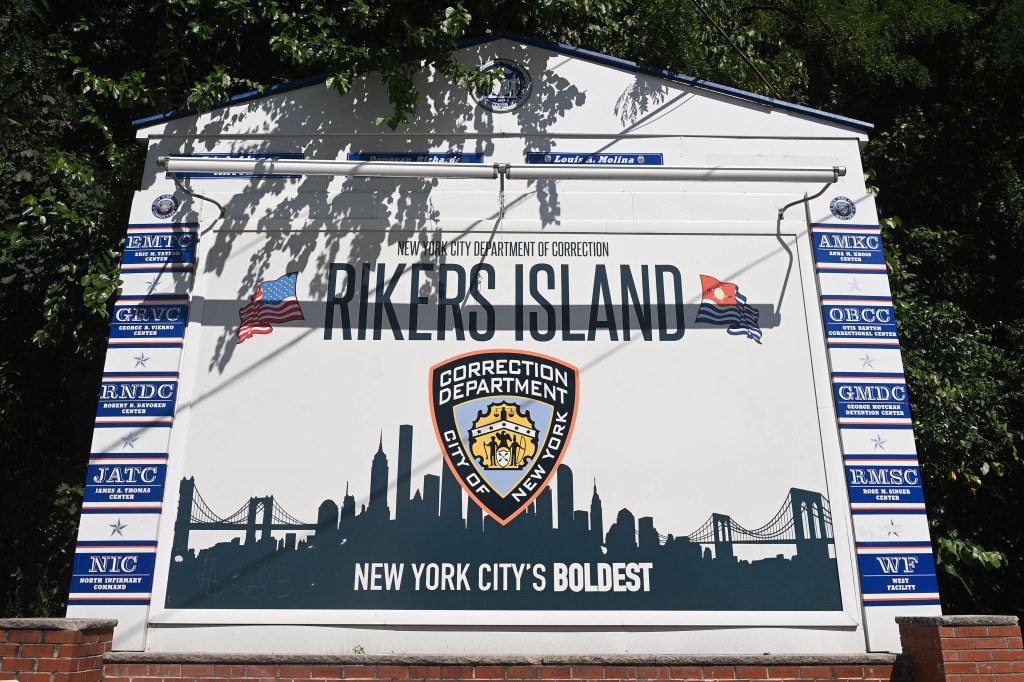 Rikers Island sign with New York City Department of Correction logo and names of various correctional facilities.