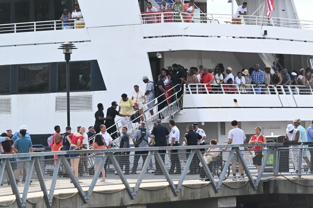 The boat's passengers getting off after the accident.
