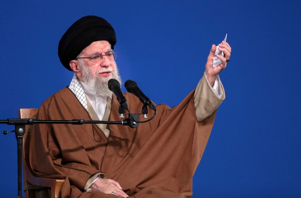 Ayatollah Ali Khamenei speaking at a podium.