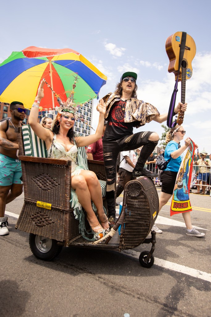 King Eugene Hütz and Queen Queenie in a rolling chair at the Coney Island Mermaid Parade.