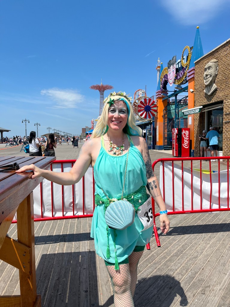Paula Carlson, a Coney Island Mermaid Parade participant, in a teal dress.