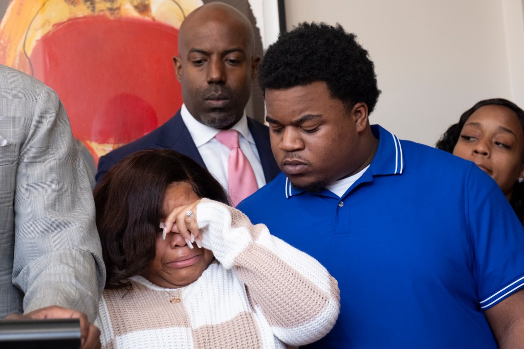 Parents of a baby who died during delivery react at a press conference.