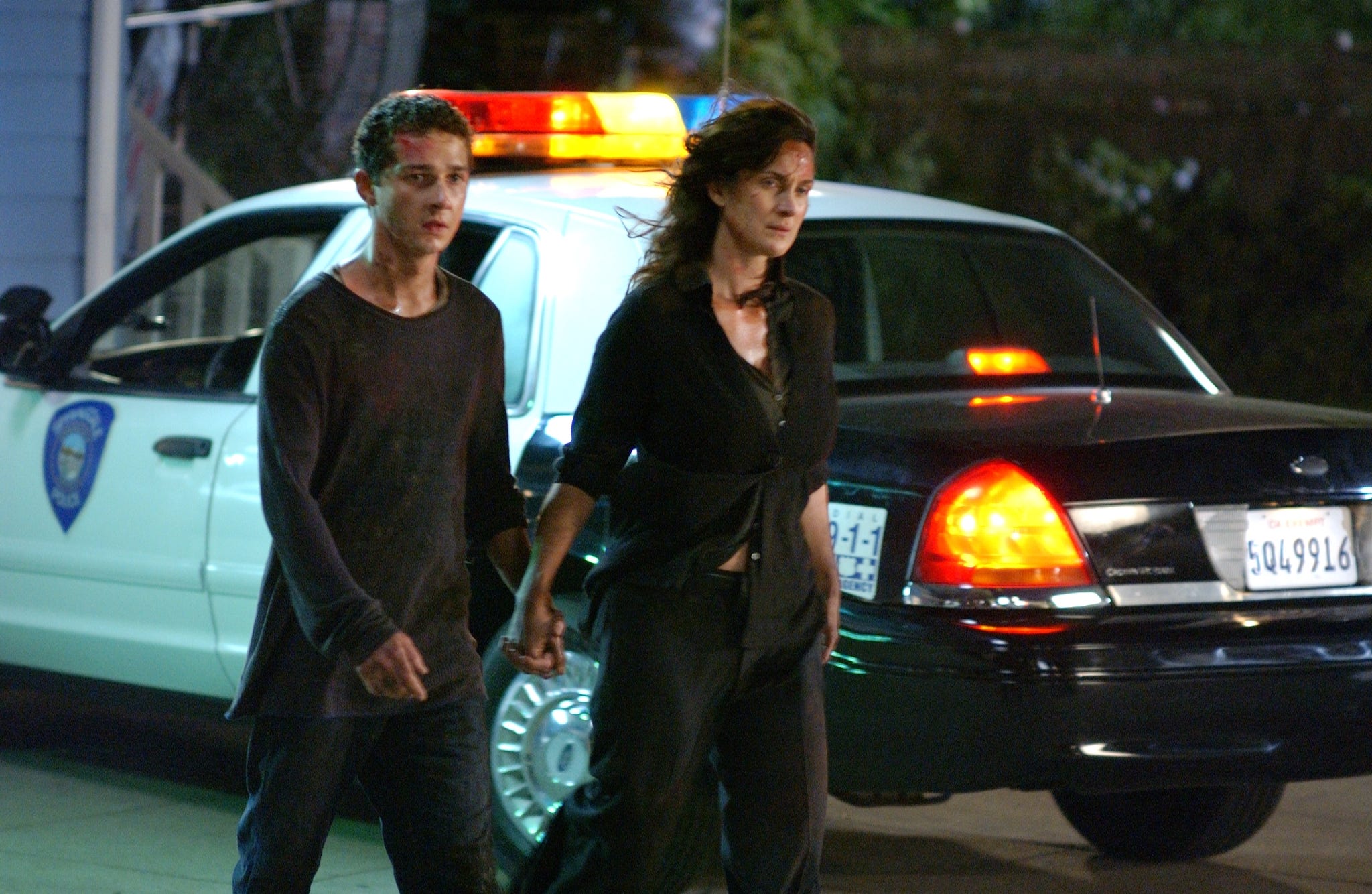 Shai LaBeouf and Carrie-Anne Moss holding hands