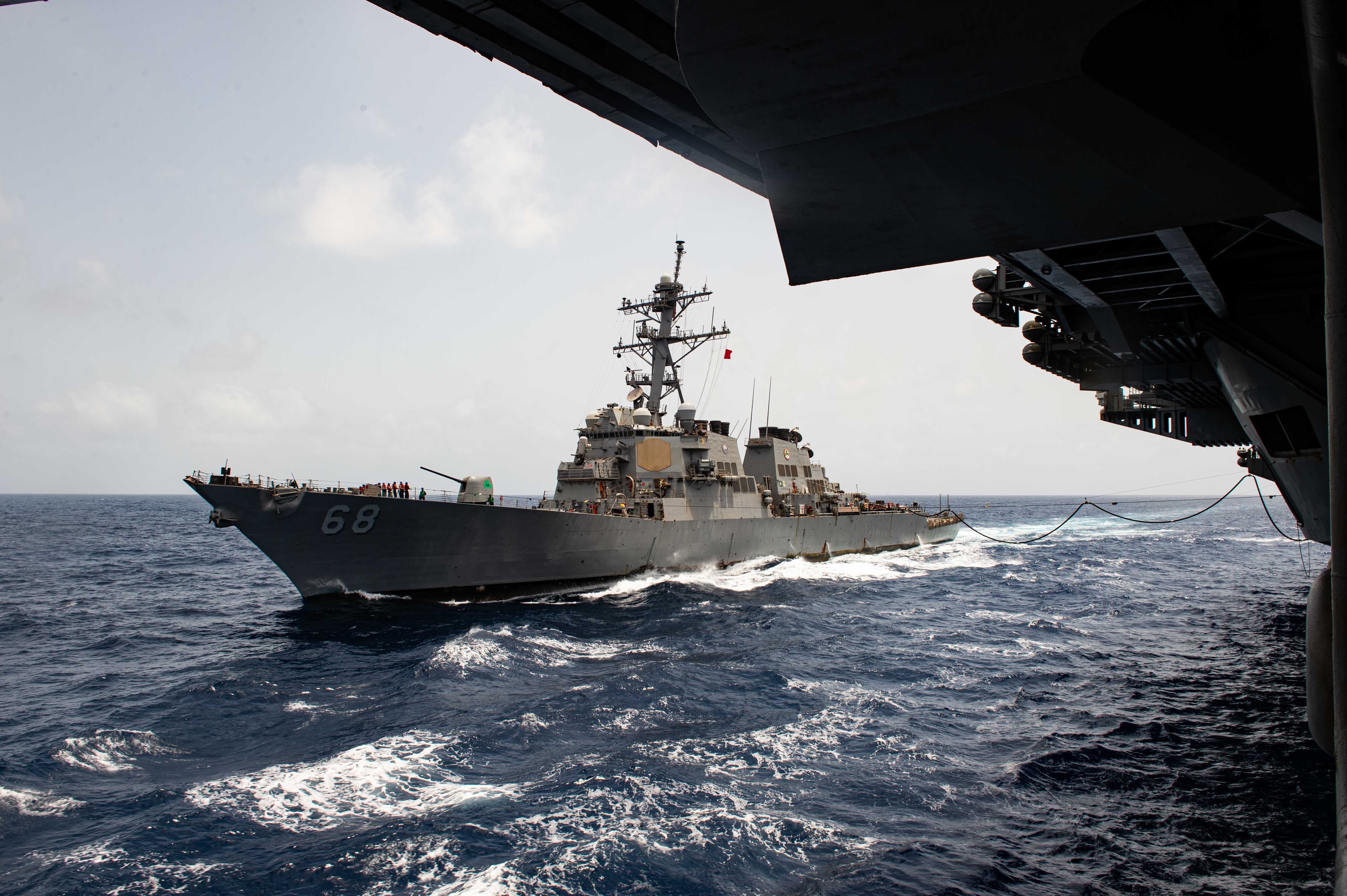 The Nimitz-class aircraft carrier USS Carl Vinson conducts a replenishment-at-sea with the Arleigh Burke-class guided-missile destroyer USS The Sullivans in the U.S. Central Command area of responsibility.