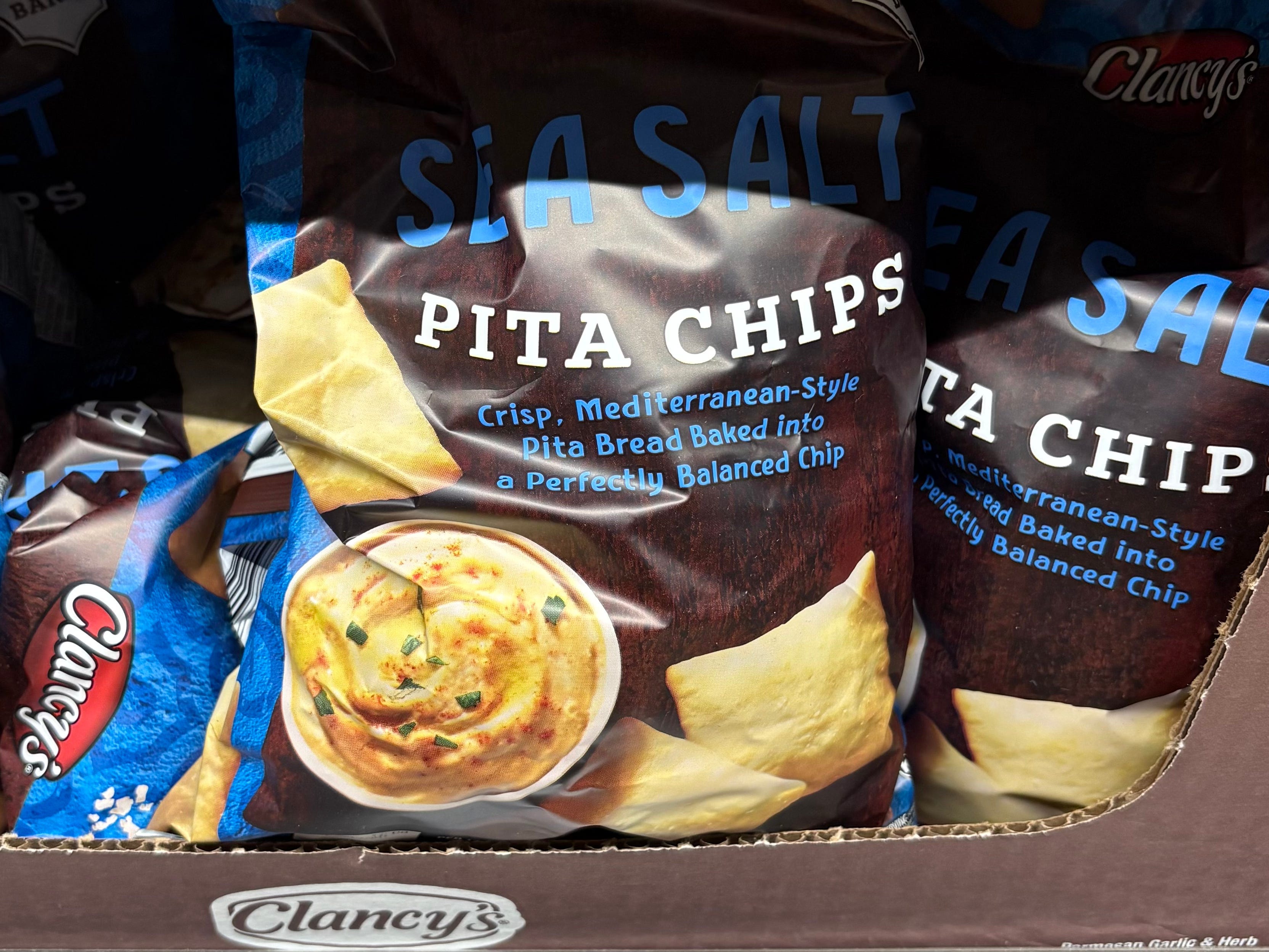 A display of bags of Clancy's sea salt pita chips.