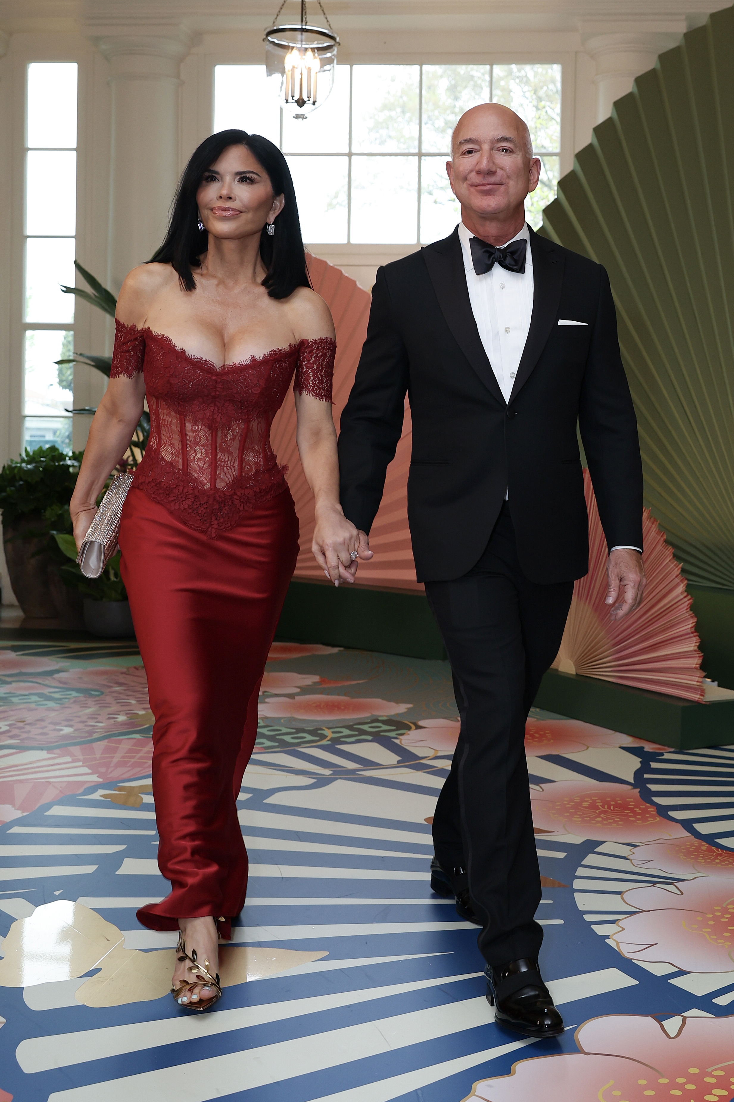 Jeff Bezos and Lauren Sánchez holding hands in 2024