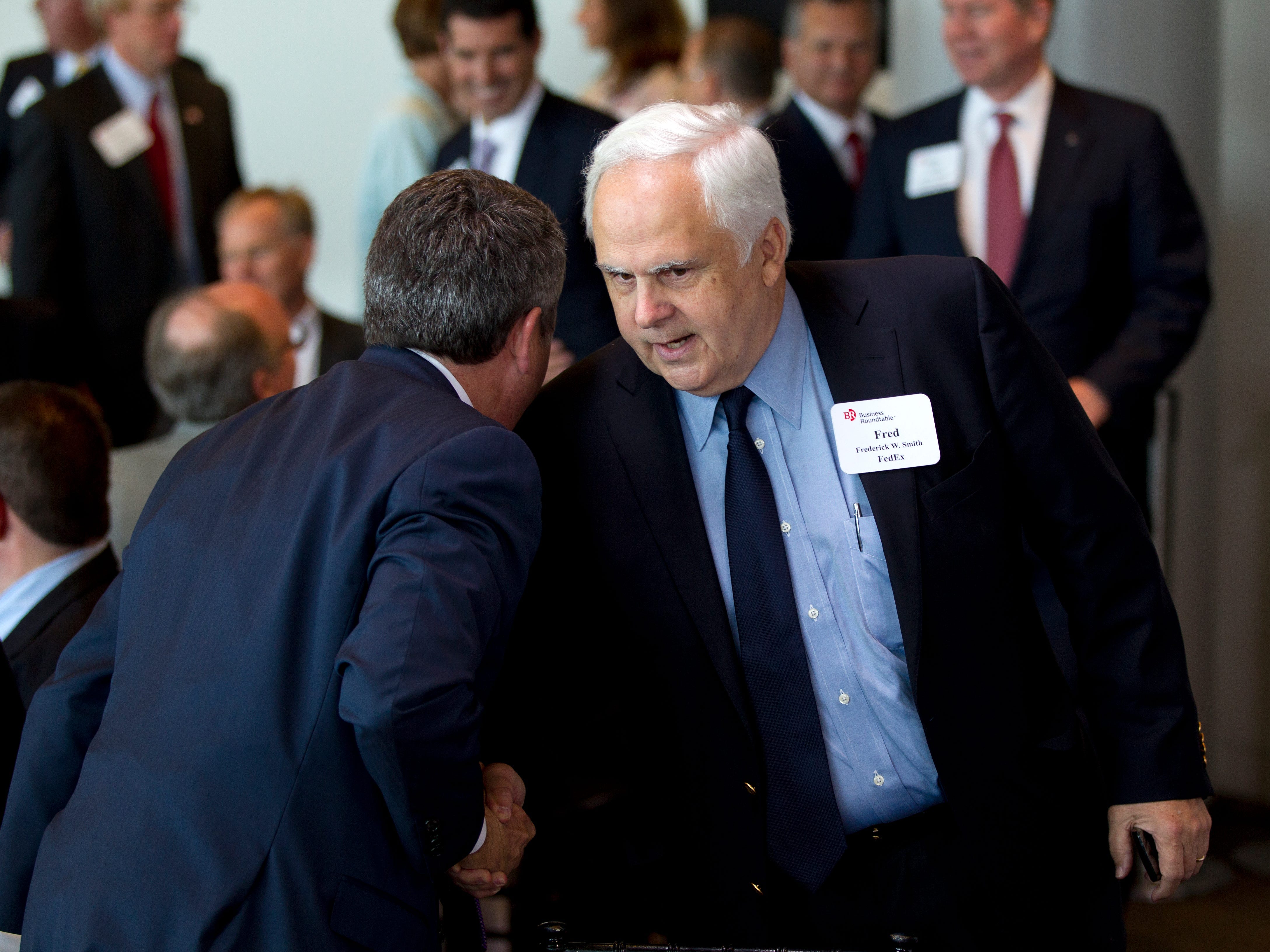 FedEx founder Fred Smith shake hands with Mitt Romney