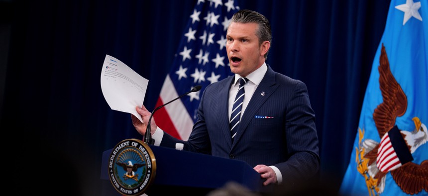 Defense Secretary Pete Hegseth waves a printout of a Donald Trump social-media post while addressing reporters at the Pentagon on June 22, 2025. It was his first live press conference since taking office in January.