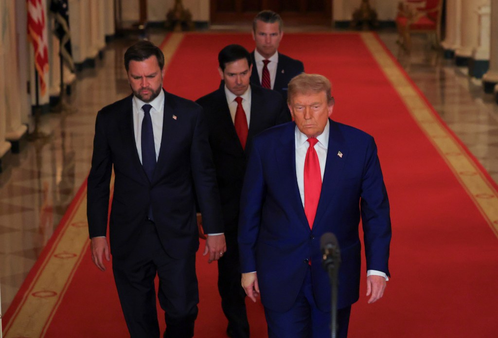 President Trump and three aides walking down a red carpet.