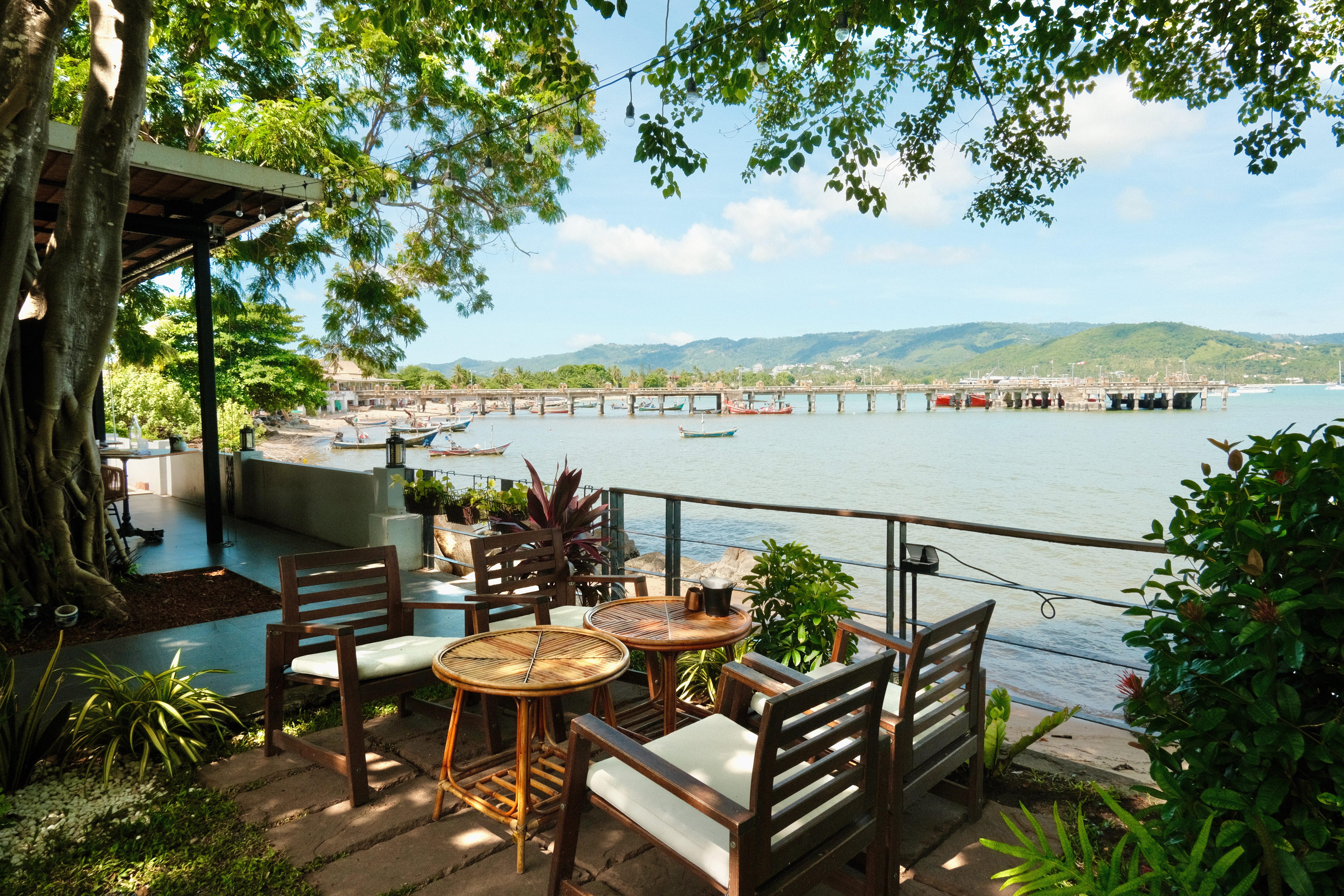 The outdoor dining area at a bistro in Koh Samui, Thailand. The venue is located by the sea.