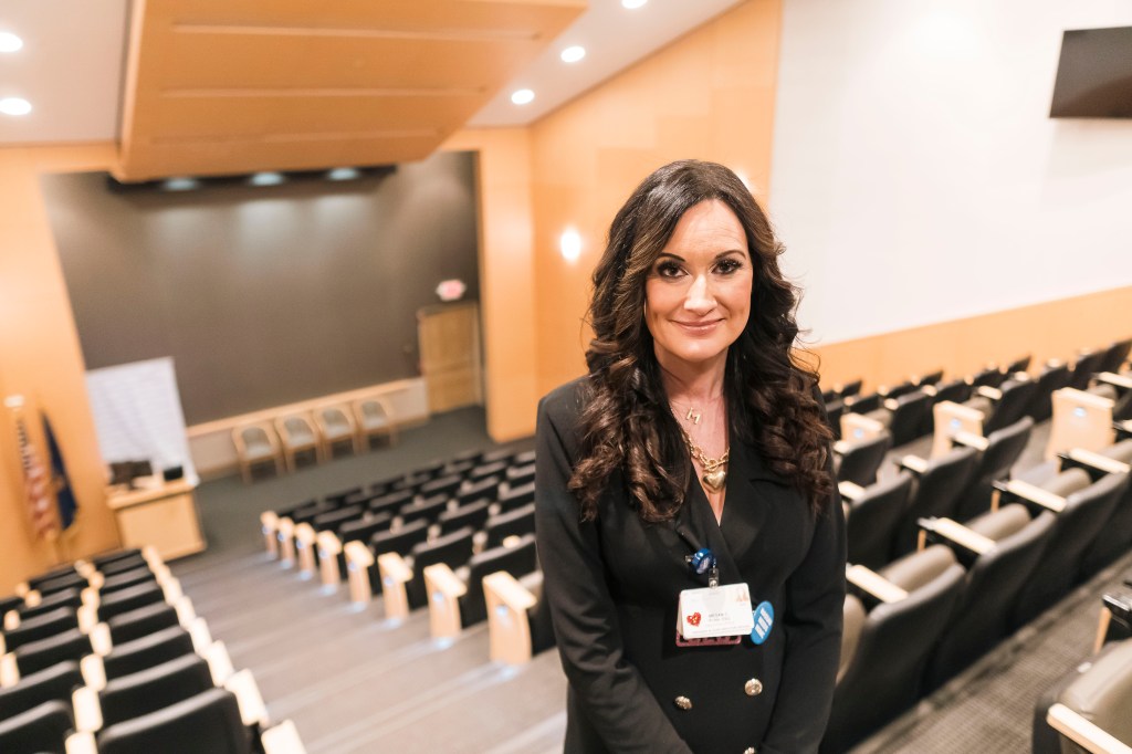 Megan Ryan, CEO and president of Nassau University Medical Center, standing in an auditorium.