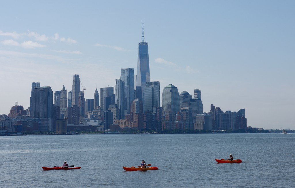 Kayakers on the Hudson River with the New York City skyline in the background.