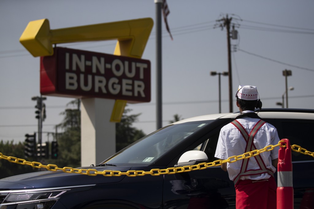 In-N-Out Burger employee taking a car order.