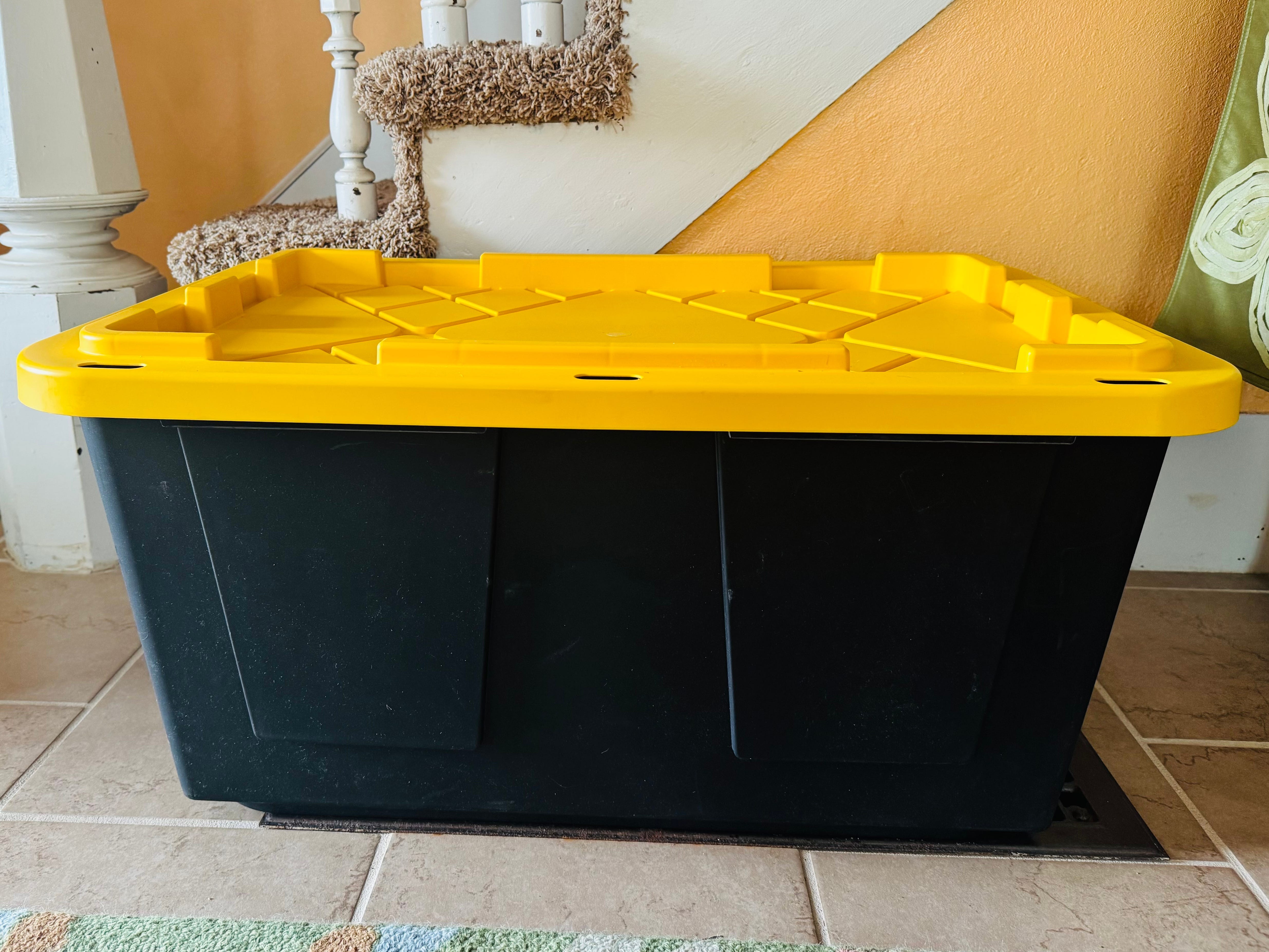 A Greenmade storage bin with a black bottom and a yellow lid.
