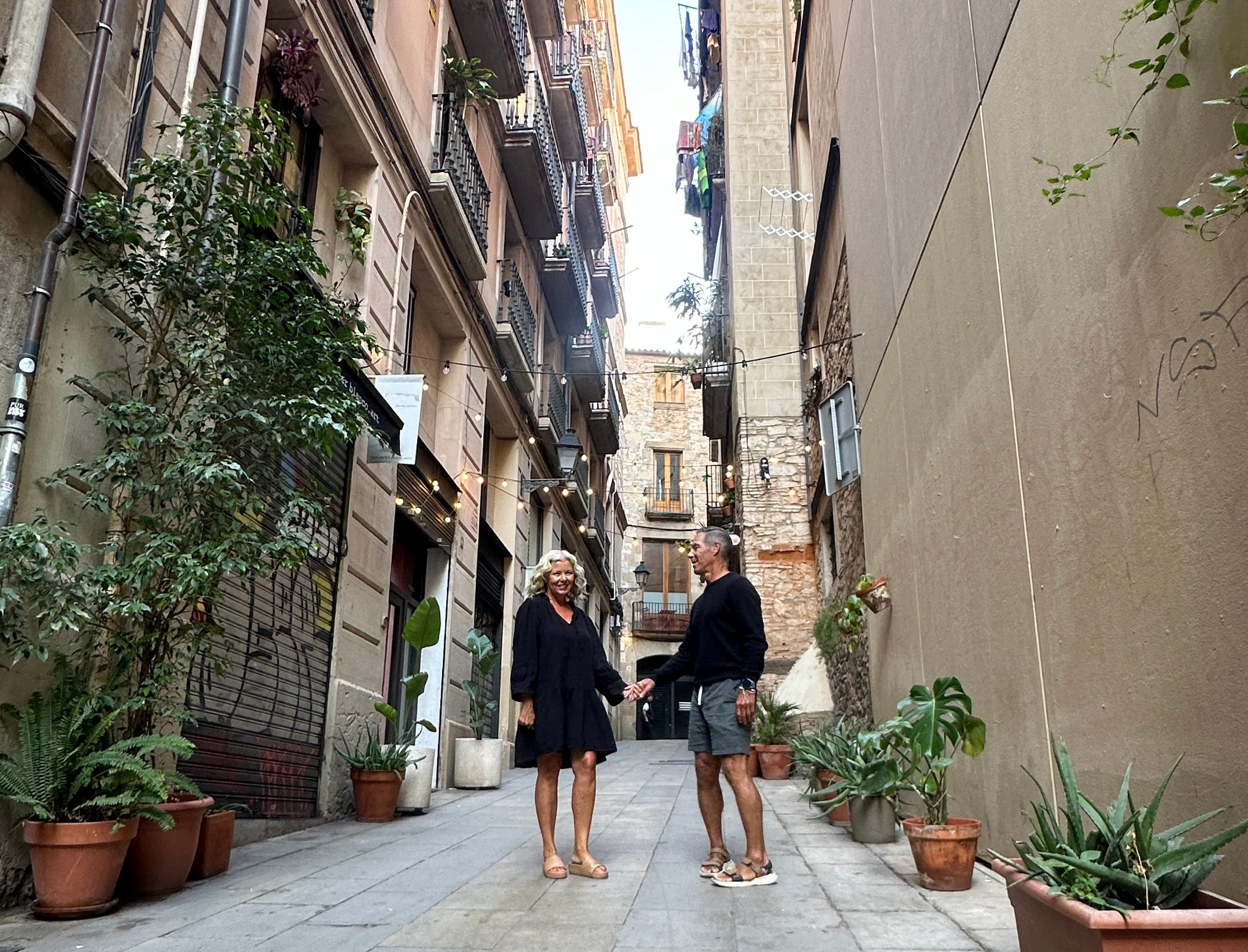The author and her husband standing in an alleyway holding hands.