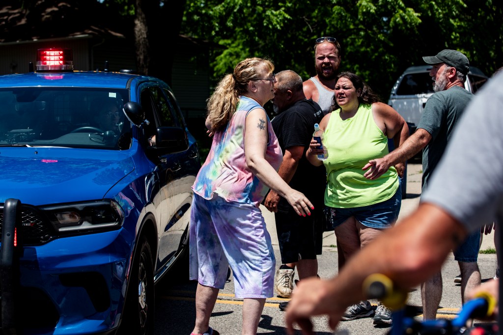 Woman speaking with police officer after church shooting.