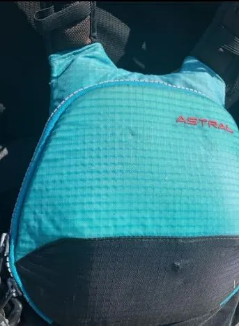 Teal Astral life vest with bite marks.
