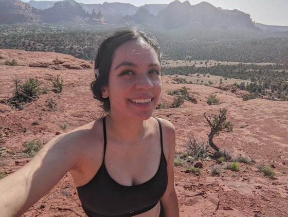 Photo of Janelle Banda in a desert landscape.