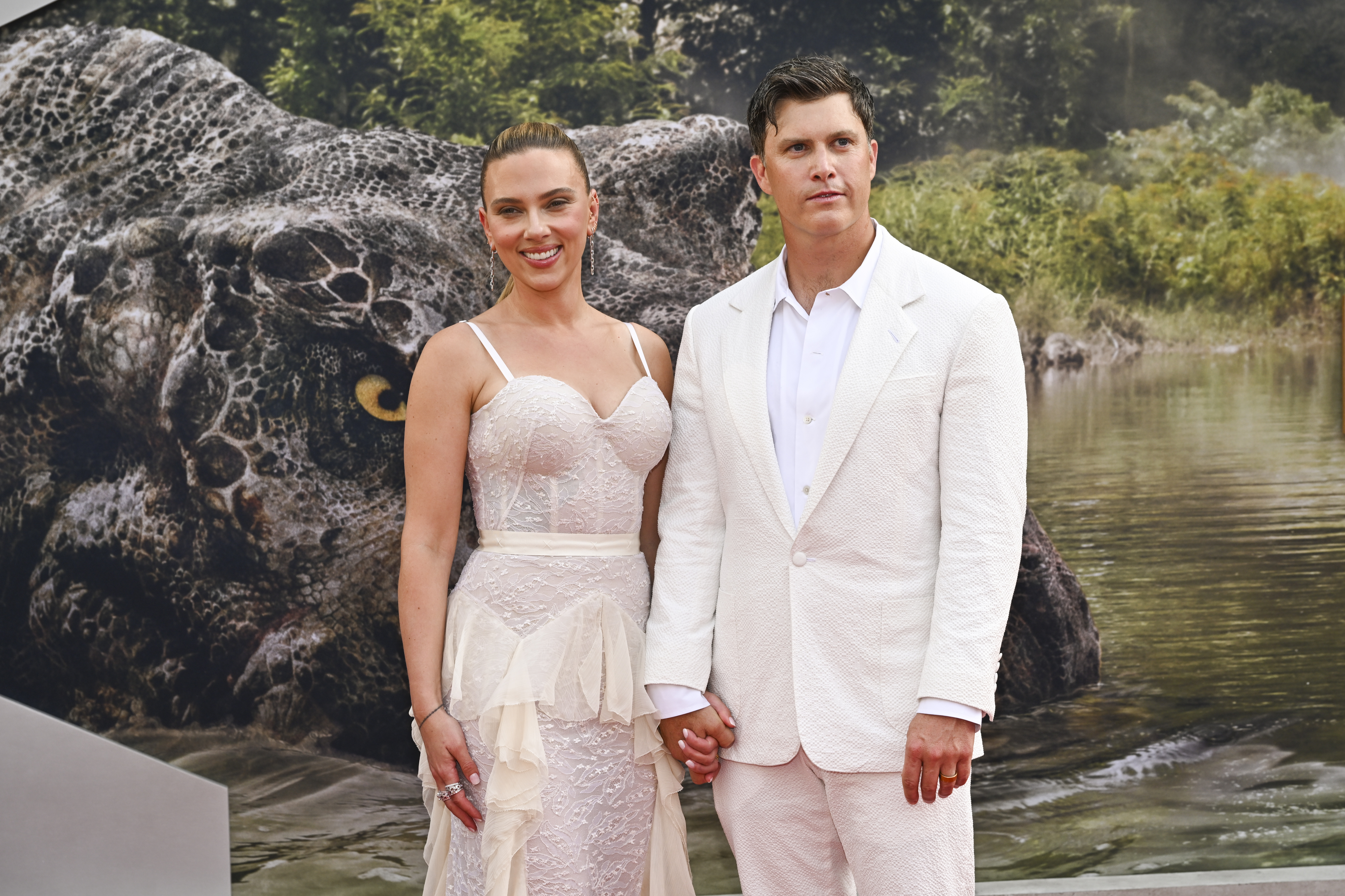 Colin Jost and Scarlett Johansson on the red carpet at an event. 