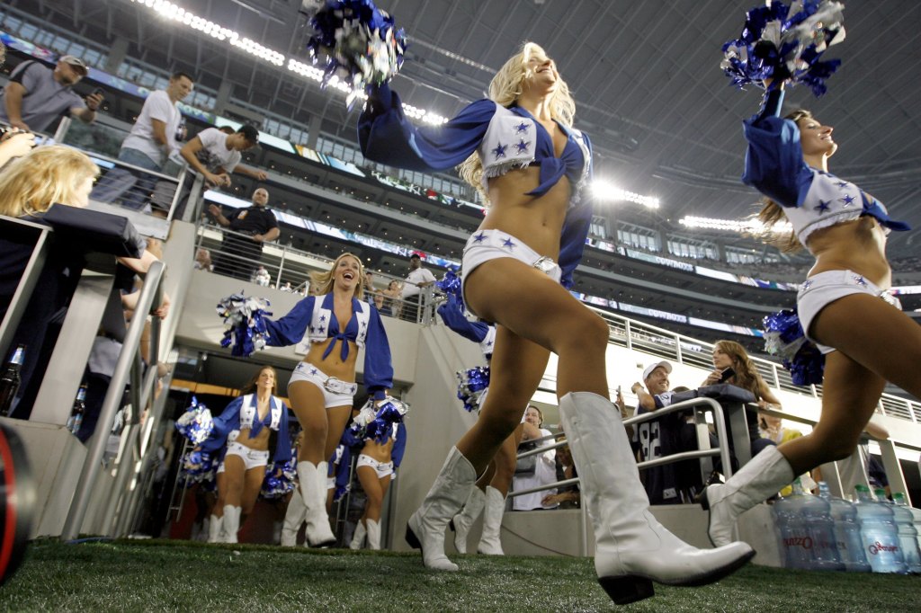 The Dallas Cowboys Cheerleaders take to the field during a preseason game against the Tennessee Titans at Dallas Cowboys Stadium on August 21, 2009 in Arlington, Texas.