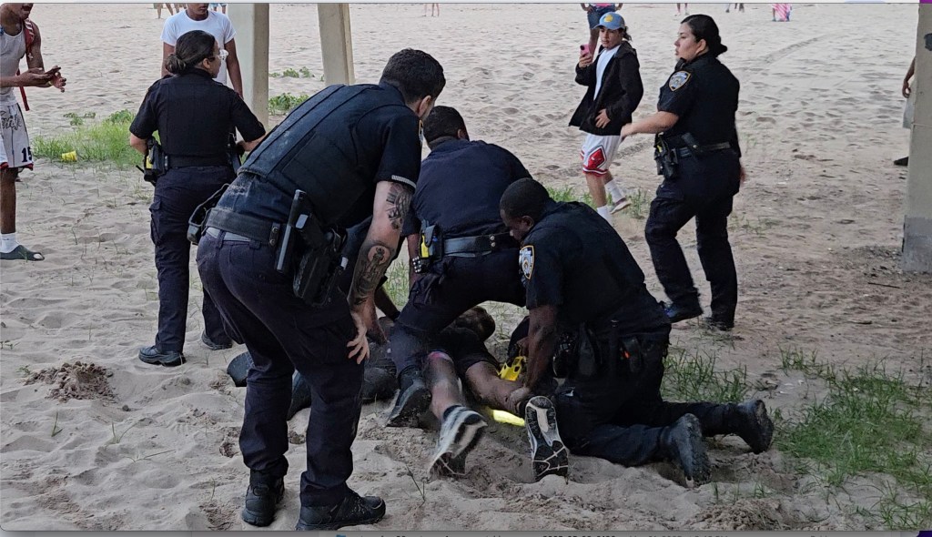 Footage shows multiple teens in handcuffs being led away by NYPD cops as a sea of teens congregate on the sand.