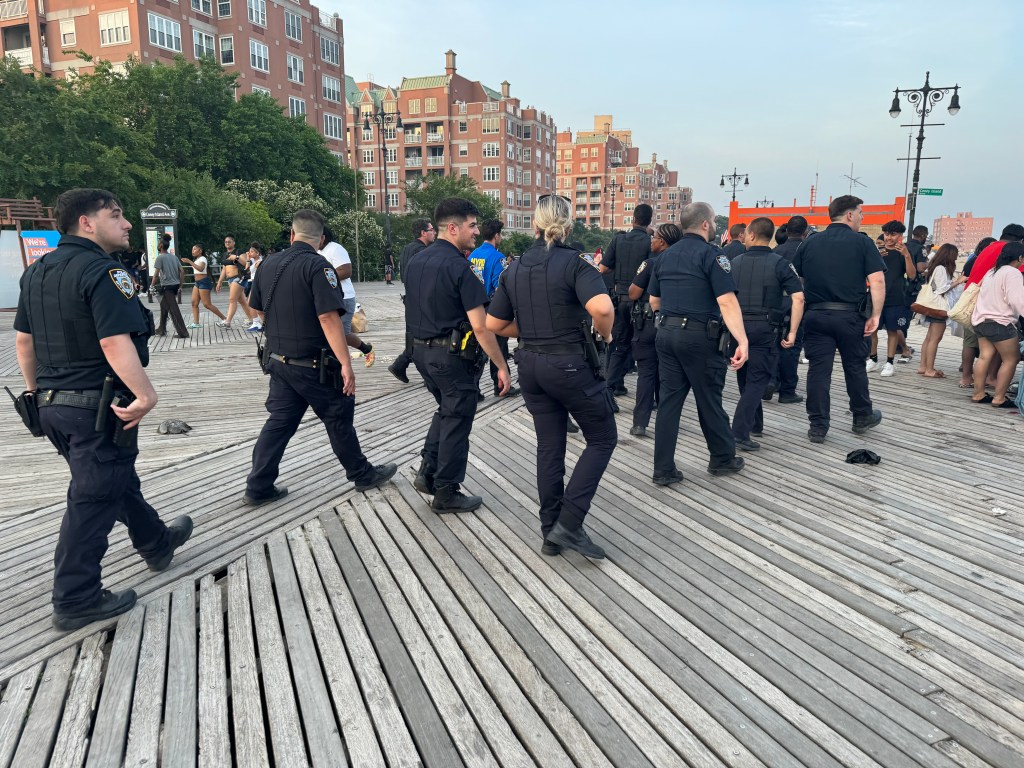 At least three dozen officers created a human barricade as cops tried to restore order to the chaotic scene. 