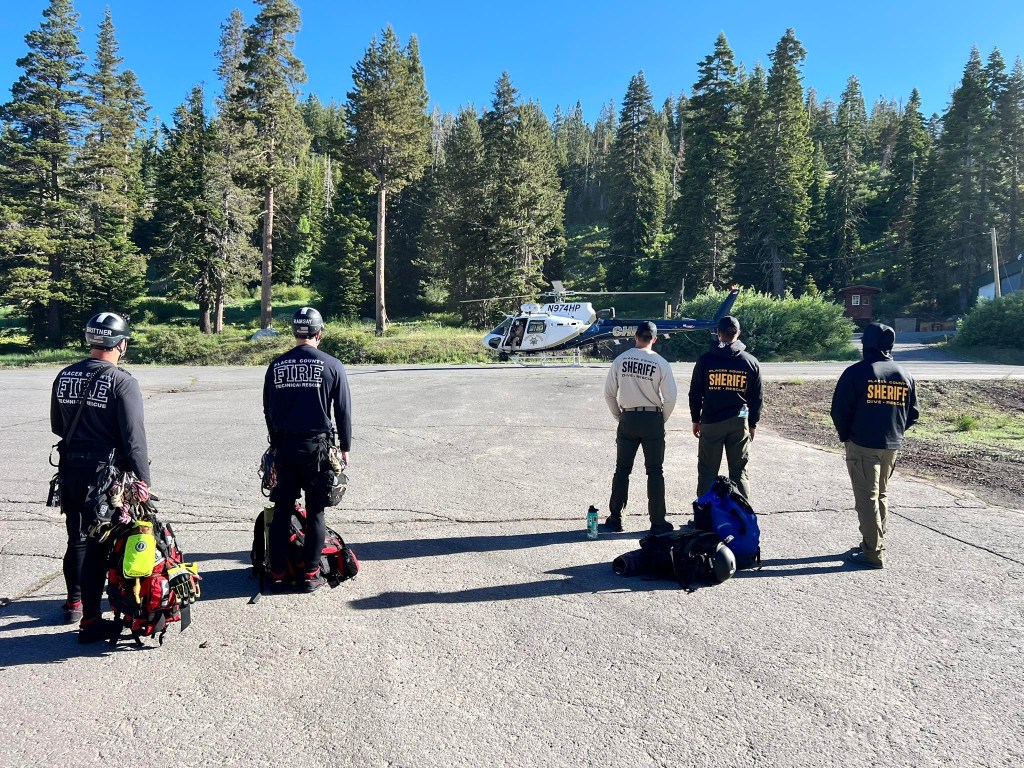 First responders and a helicopter at a rescue scene.