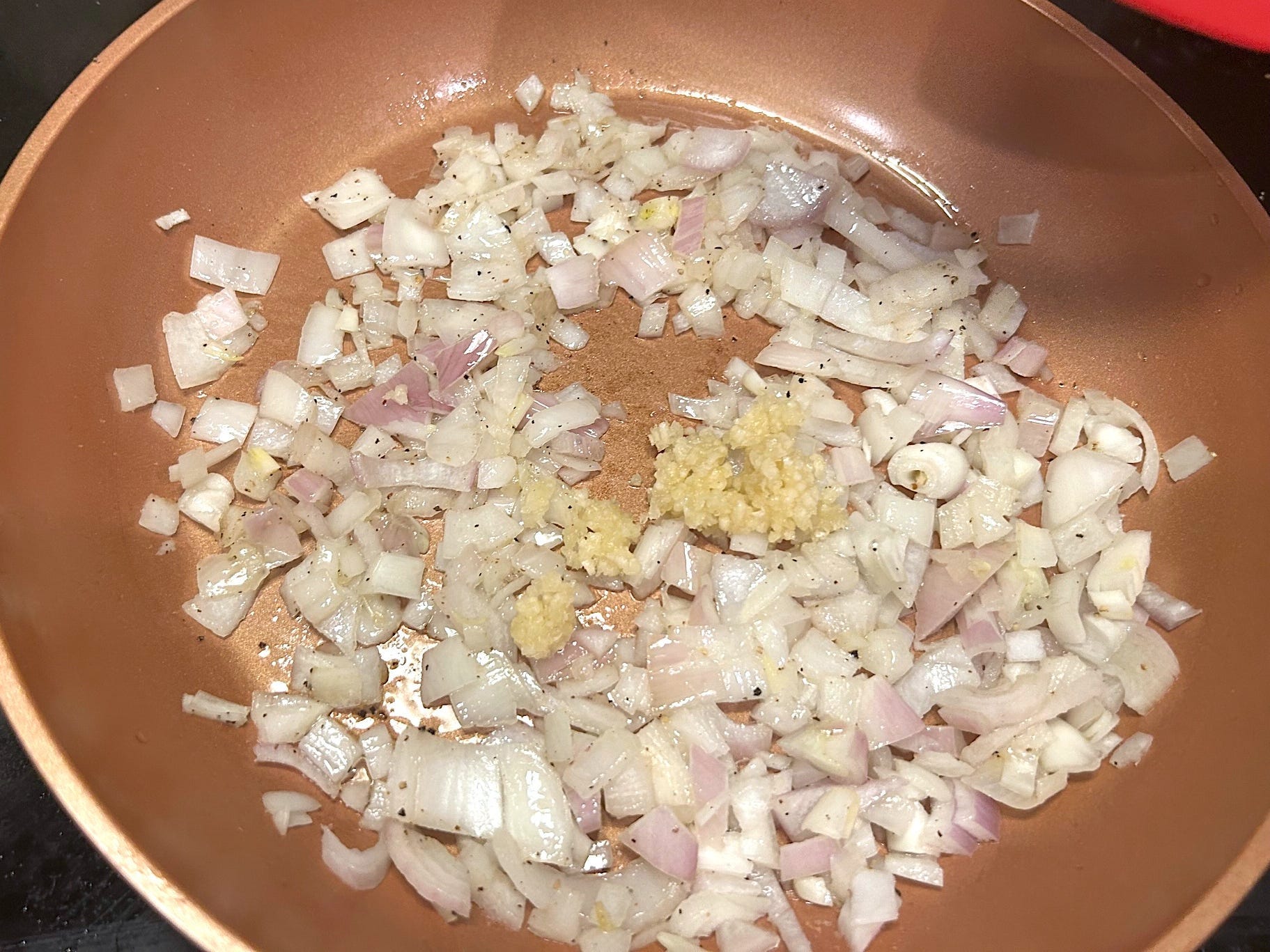 Adding onions and garlic to pan for Gordon Ramsay's 10-minute scampi