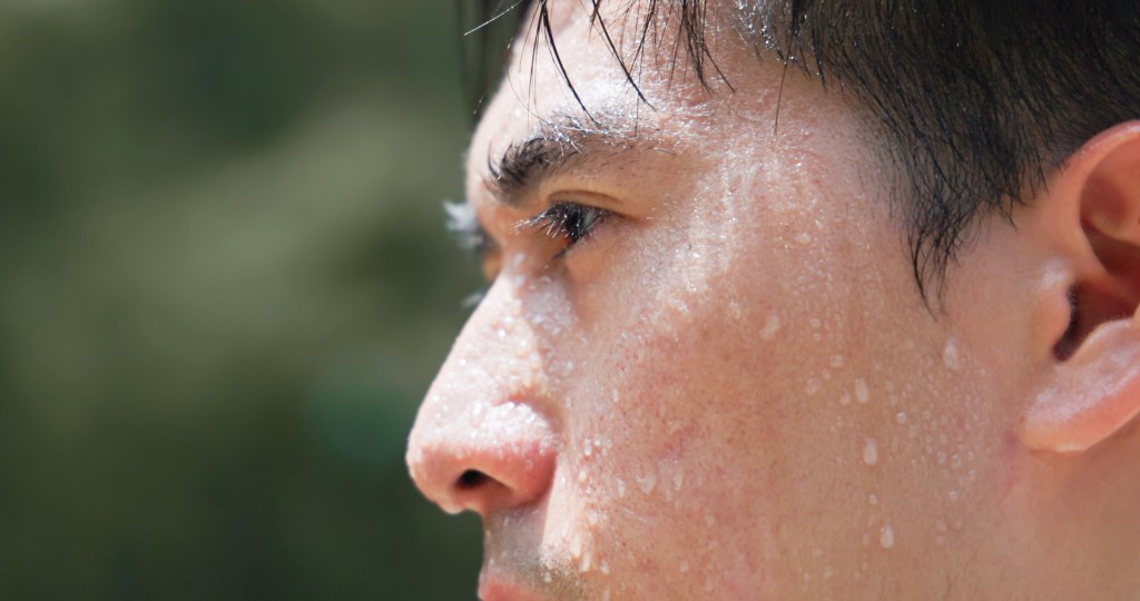 Close-up of a sweating man's face.