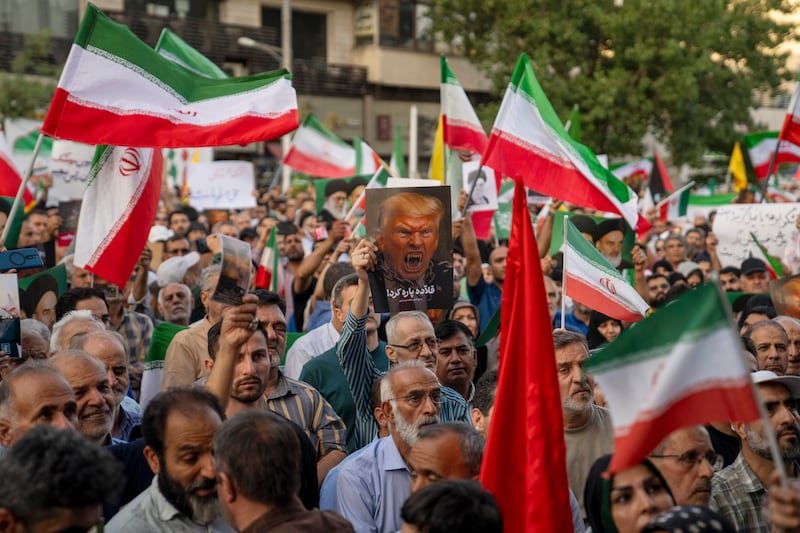TEHRAN, IRAN - JUNE 22: Iranian protesters chant slogans and one holds a poster with a vampire-like illustration of US President Donald Trump in Revolution Square to protest US attacks on nuclear sites in Iran on June 22, 2025 in Tehran, Iran. In the early hours of June 22, the United States dropped a series of bombs on several alleged nuclear facilities in Iran, joining Israel's ongoing war with the country. Iran responded with a barrage of missiles at Israel and promised retaliation against US interests in the region. (Photo by Getty Images)